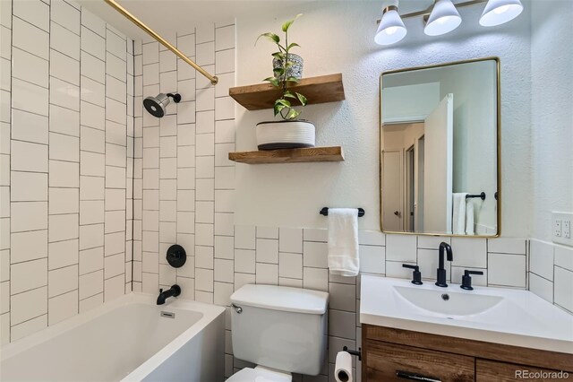 3955 S Nucla St, Aurora, CO 80013 - full bath with vanity, tub / shower combination, tile walls, and tasteful backsplash