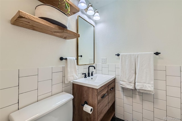 3955 S Nucla St, Aurora, CO 80013 - half bath with tile walls, vanity, and wainscoting
