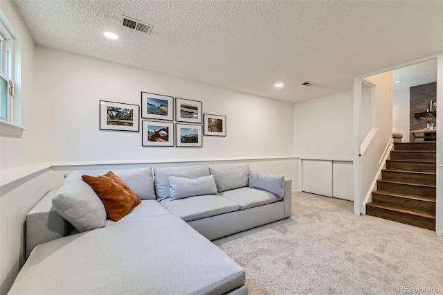 3955 S Nucla St, Aurora, CO 80013 - carpeted living area featuring a textured ceiling, stairway, and recessed lighting