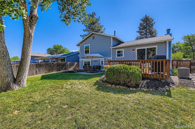 3955 S Nucla St, Aurora, CO 80013 - rear view of house featuring a fenced backyard, a chimney, a deck, and a patio area