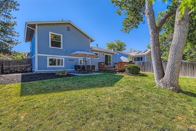 3955 S Nucla St, Aurora, CO 80013 - rear view of house featuring a fenced backyard, stucco siding, and a patio