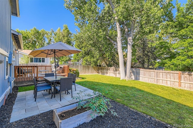 3955 S Nucla St, Aurora, CO 80013 - fenced backyard with a vegetable garden, outdoor dining area, and a patio