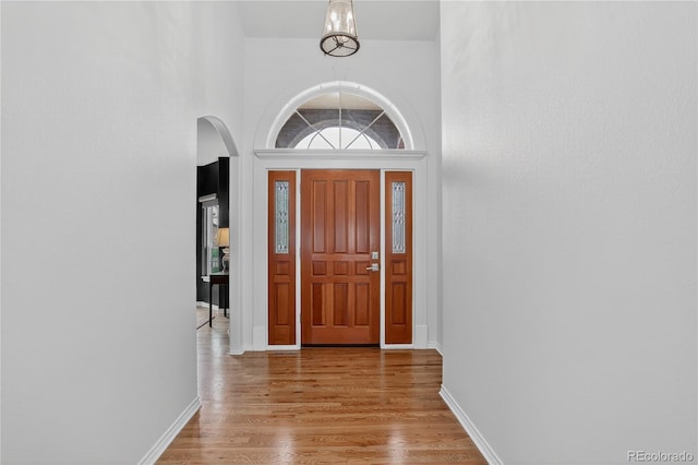5926 S Elkhart Ct, Centennial, CO 80016 - foyer with arched walkways, light wood-type flooring, and a high ceiling
