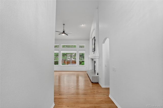 5926 S Elkhart Ct, Centennial, CO 80016 - hall featuring arched walkways, light wood-type flooring, and recessed lighting