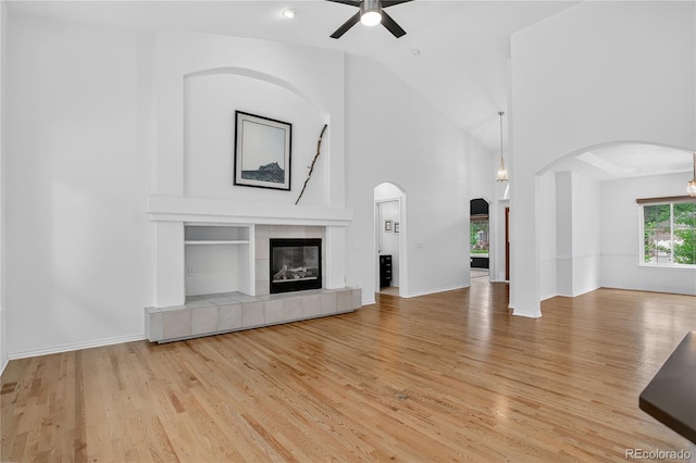 5926 S Elkhart Ct, Centennial, CO 80016 - unfurnished living room with a ceiling fan, wood finished floors, arched walkways, and vaulted ceiling