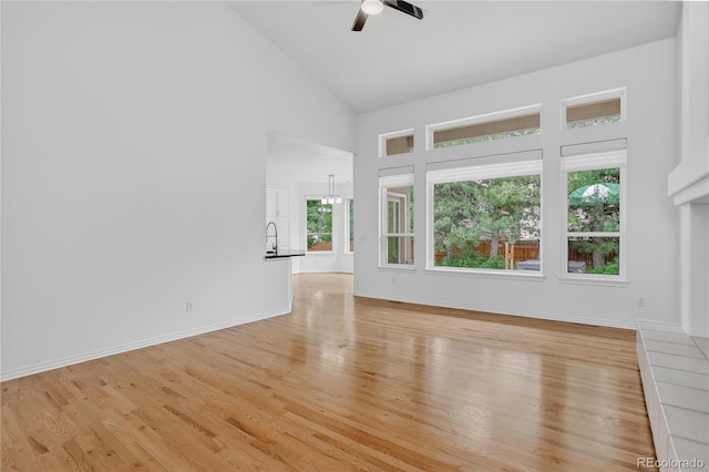 5926 S Elkhart Ct, Centennial, CO 80016 - unfurnished living room with high vaulted ceiling, ceiling fan, and light wood finished floors