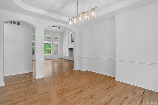 5926 S Elkhart Ct, Centennial, CO 80016 - unfurnished dining area featuring light wood-style flooring, arched walkways, and crown molding