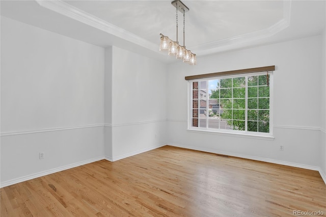 5926 S Elkhart Ct, Centennial, CO 80016 - spare room with wood finished floors, a raised ceiling, and crown molding