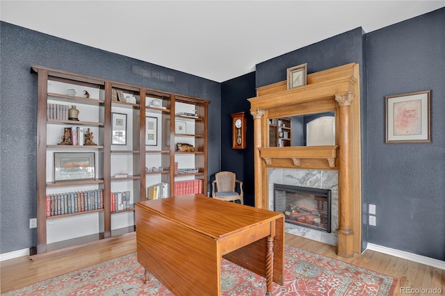 5926 S Elkhart Ct, Centennial, CO 80016 - office with wood finished floors, a high end fireplace, and a textured wall