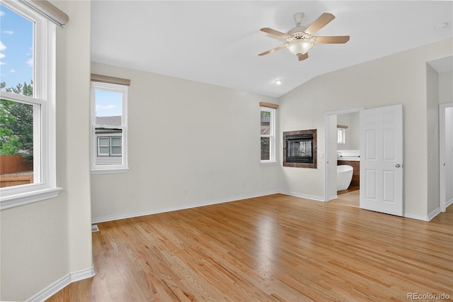 5926 S Elkhart Ct, Centennial, CO 80016 - unfurnished living room with light wood-type flooring, a multi sided fireplace, a ceiling fan, and lofted ceiling
