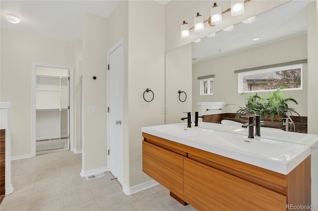5926 S Elkhart Ct, Centennial, CO 80016 - full bath featuring double vanity, tile patterned floors, and a walk in closet