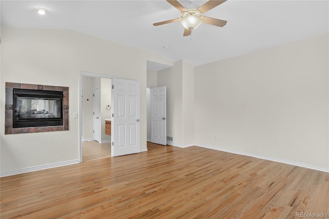 5926 S Elkhart Ct, Centennial, CO 80016 - spare room with vaulted ceiling, light wood-type flooring, ceiling fan, and a multi sided fireplace