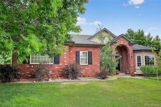 5926 S Elkhart Ct, Centennial, CO 80016 - view of front of house featuring a front lawn, brick siding, and a shingled roof