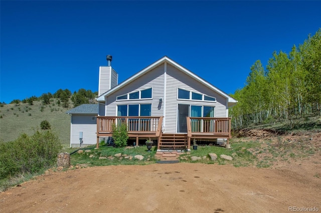 1536 County Road 1, Cripple Creek, CO 80813 - back of property featuring a wooden deck and a chimney