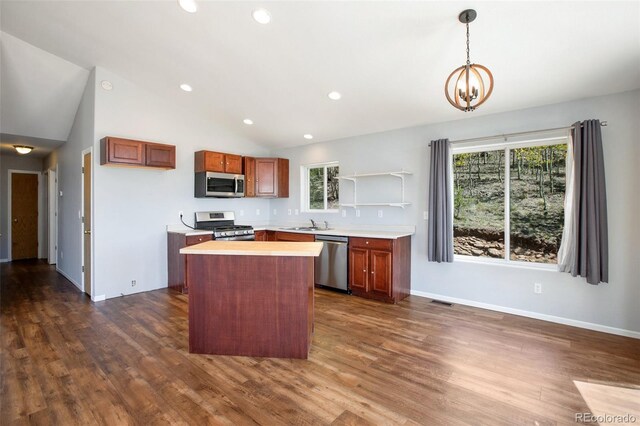 1536 County Road 1, Cripple Creek, CO 80813 - kitchen with stainless steel appliances, light countertops, dark wood-type flooring, a center island, and vaulted ceiling