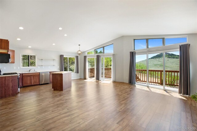 1536 County Road 1, Cripple Creek, CO 80813 - kitchen featuring stainless steel dishwasher, open floor plan, range with gas cooktop, a kitchen island, and dark wood-style floors