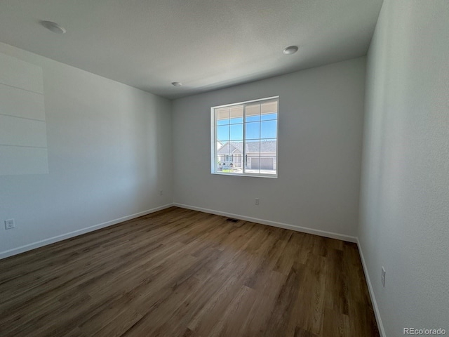 6170 Amerifax Dr, Windsor, CO 80528 - empty room with dark wood-style flooring and baseboards