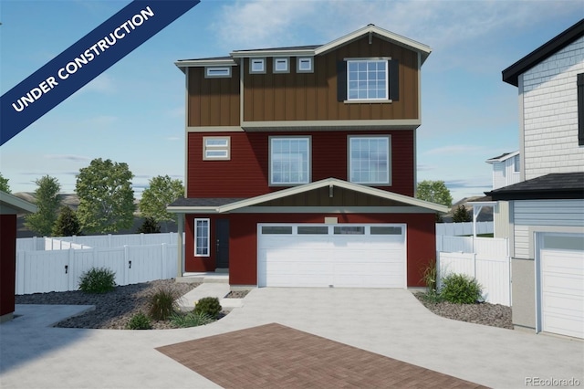 view of front of property featuring decorative driveway, fence, board and batten siding, and an attached garage