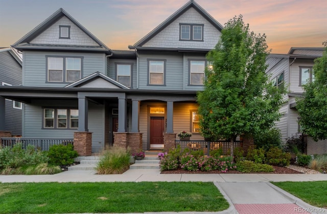 5735 Boston St, Denver, CO 80238 - craftsman-style home featuring covered porch and a front lawn