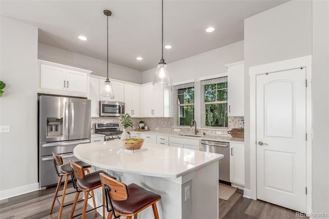 5735 Boston St, Denver, CO 80238 - kitchen with appliances with stainless steel finishes, dark wood-style floors, backsplash, and recessed lighting
