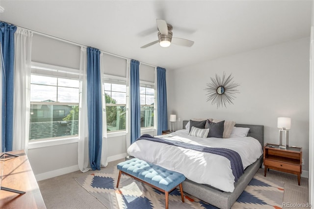 5735 Boston St, Denver, CO 80238 - bedroom featuring multiple windows, light colored carpet, and a ceiling fan