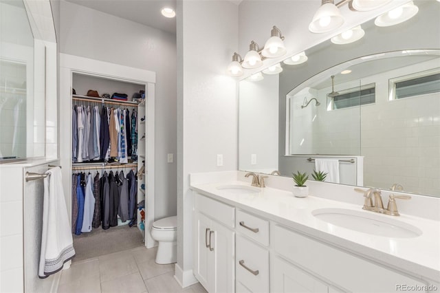 5735 Boston St, Denver, CO 80238 - full bath featuring tile patterned floors, double vanity, a spacious closet, and walk in shower