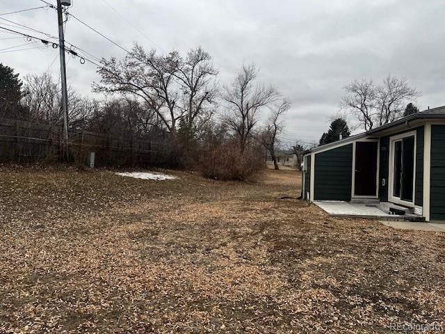 view of yard with fence and a patio