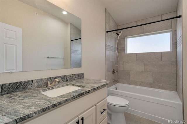 full bathroom featuring tiled shower / bath combo, vanity, toilet, and tile patterned flooring