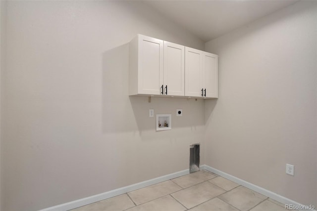 clothes washing area with hookup for a washing machine, cabinets, hookup for an electric dryer, and light tile patterned flooring