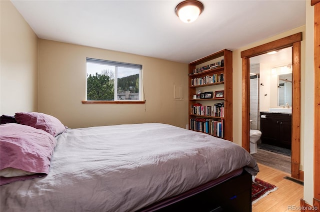 32 Magnum Bonum Dr, Breckenridge, CO 80424 - bedroom with light wood-style flooring, ensuite bath, and a sink