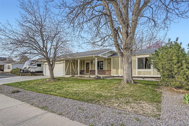 ranch-style home featuring concrete driveway, covered porch, brick siding, a front yard, and a garage