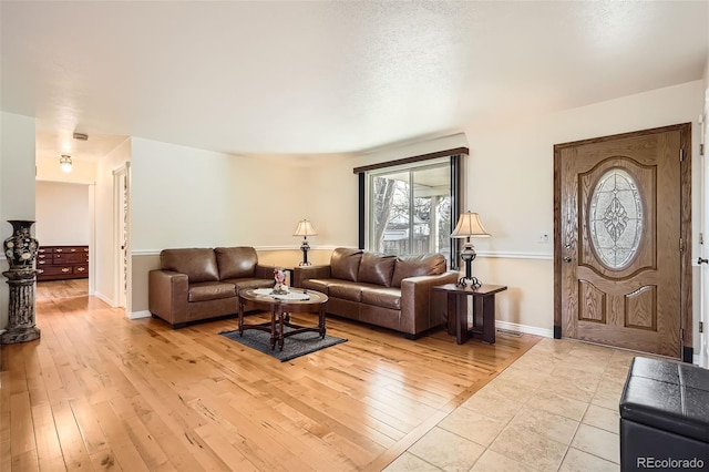 living room with baseboards and light wood-type flooring
