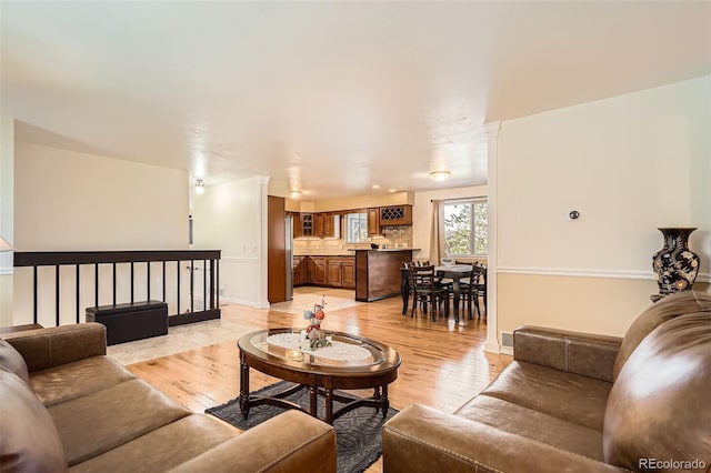 living room featuring baseboards and light wood-style floors