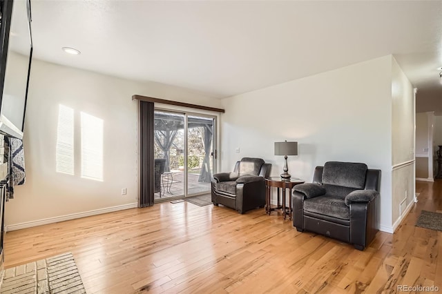 sitting room featuring light wood-style flooring and baseboards
