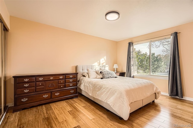 bedroom featuring baseboards and light wood-style floors