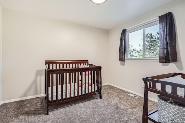 bedroom featuring carpet floors, visible vents, and baseboards