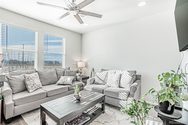 living room with ceiling fan and light hardwood / wood-style flooring