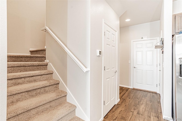 stairs featuring hardwood / wood-style floors