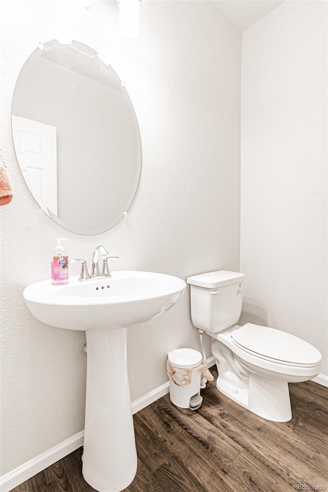 bathroom featuring hardwood / wood-style floors and toilet