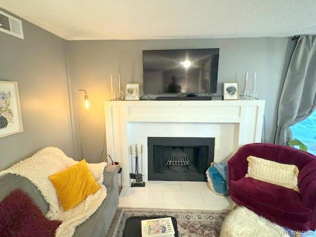 12546 E Cornell Ave Unit 104, Aurora, CO 80014 - living room with a fireplace with raised hearth and a textured ceiling