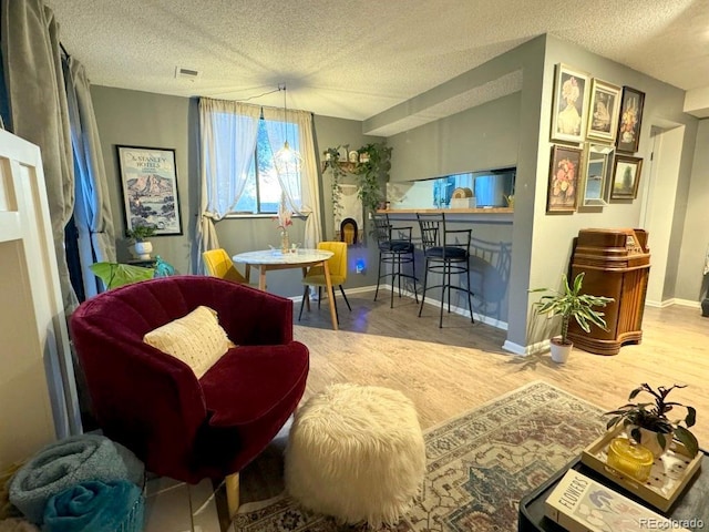 12546 E Cornell Ave Unit 104, Aurora, CO 80014 - living area with wood finished floors and a textured ceiling