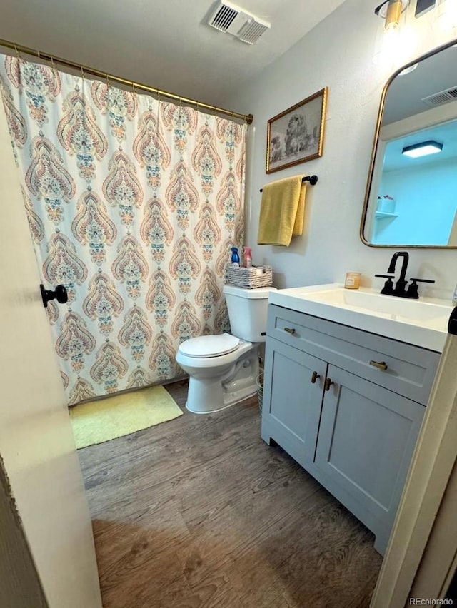 12546 E Cornell Ave Unit 104, Aurora, CO 80014 - full bath featuring vanity, wood finished floors, and curtained shower