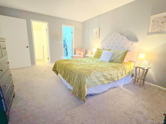 12546 E Cornell Ave Unit 104, Aurora, CO 80014 - carpeted bedroom featuring ensuite bathroom and baseboards