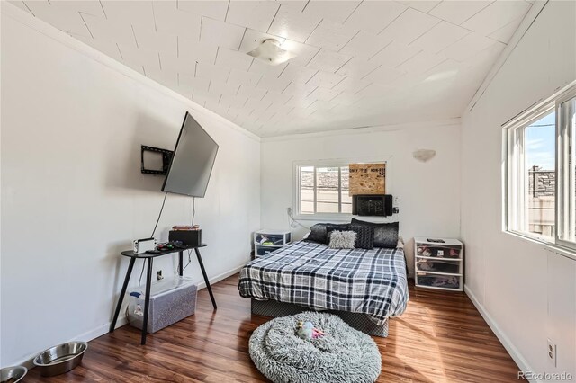 bedroom featuring ornamental molding and hardwood / wood-style flooring