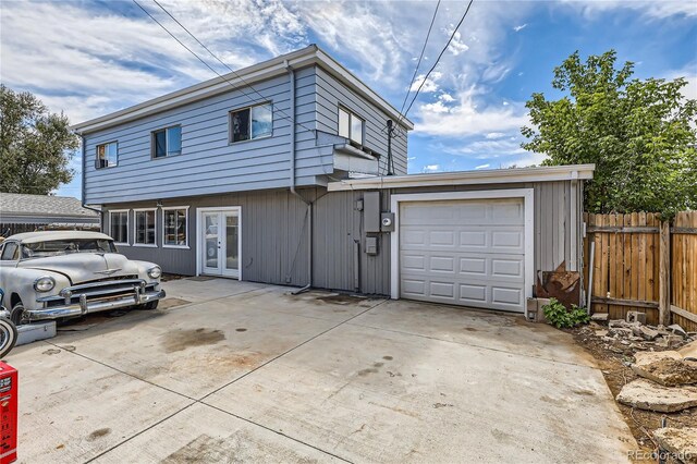 view of front property with french doors and a garage