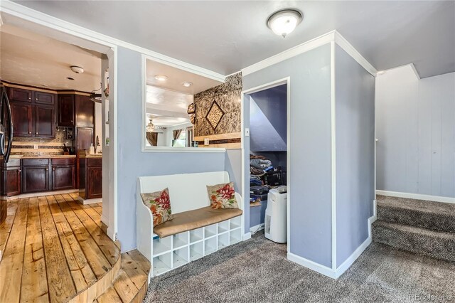 interior space with wood-type flooring and ornamental molding