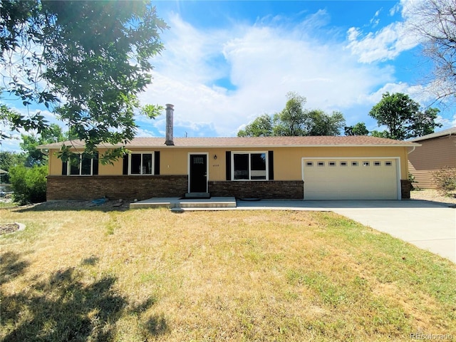 4559 Ashfield Dr, Boulder, CO 80301 - ranch-style home featuring an attached garage, concrete driveway, a front yard, and brick siding