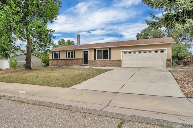 4559 Ashfield Dr, Boulder, CO 80301 - ranch-style house with brick siding, an attached garage, and driveway