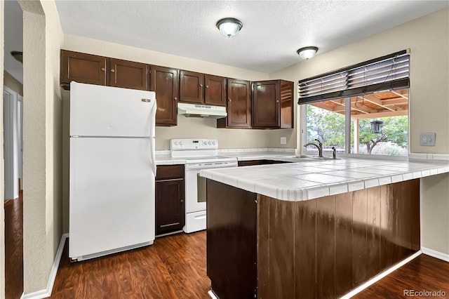 4559 Ashfield Dr, Boulder, CO 80301 - kitchen with white appliances, under cabinet range hood, dark brown cabinetry, tile counters, and a textured ceiling