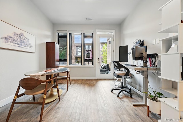 home office featuring wood finished floors and baseboards